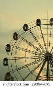 ferriswheel in the corner of indonesian city at dusk