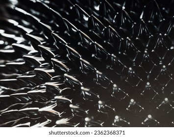 Ferrofluid black spikes. Reaction to a magnetic field. Minimalistic futuristic macro photo.