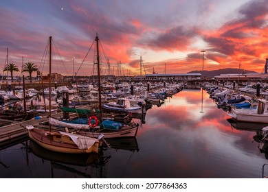 Ferrol, Spain. November 9, 2021. Dramatic sunset over Ferrol old port. Small fishing and recreational boats moored on docks. Galicia, Spain