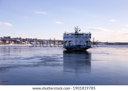 The ferry across the St. Lawrence River arriving at Quebec City from Levis during a cold clear winter afternoon, Quebec, Canada