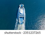 Ferry boat crossing the sea, carrying cars and passengers, deck of a boat carrying vehicles. Aerial view