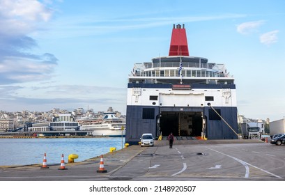 Ferry Boat Loading Or Unloading In Seaport Of Piraeus Near Athens, Greece. Large Ferryboat Docked In Sea Harbor, Big Ship At Port Pier. Concept Of Car Transportation, Ferryboat, Shipping And Travel.