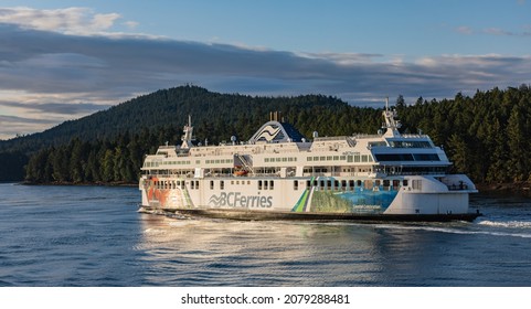Ferry in front of Coast Mountains. BC Ferry crossing the strait in gulf islands national park. BC Ferries, Vancouver, Canada, boat, river, ferries, British Columbia. July 21,2021