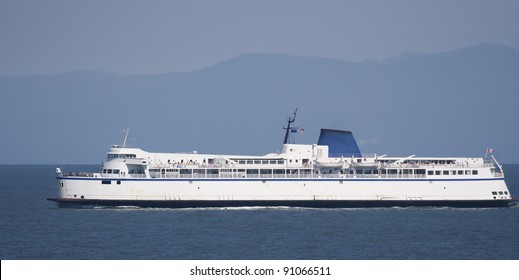 Ferry in front of Coast Mountains - British Columbia, Canada
