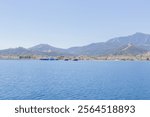 Ferry port at Thasos Island, Greece, with ferries docked and scenic mountain views in the background