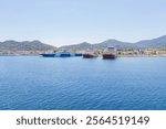 Ferry port at Thasos Island, Greece, with ferries docked and scenic mountain views in the background