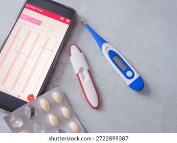 Fertility tracking tools, including a BBT thermometer, an app displaying a temperature chart, and supplements for pregnancy planning. A modern approach to women's reproductive health.