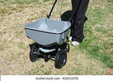 Fertilizing The Lawn By Fertilizer Spreader