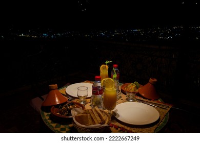 Fes, Morocco - September 01, 2022; Dinner Table With Wicker Lamp At Night In The Terrace Of A Riad