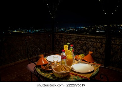 Fes, Morocco - September 01, 2022; Dinner Table With Wicker Lamp At Night In The Terrace Of A Riad