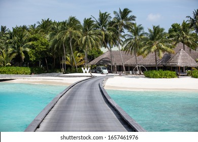Fesdhoo, Maldives - February 8 2020: Wooden Walkway To The Beach And W Hotels Logo At W Maldives