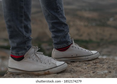 Fes/Morocco - November 06, 2020; Man With Gray Jeans And White Converse And Multi-colored Socks Standing On The Edge Of The Ground