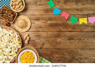 Festa Junina party background with popcorn, peanuts and traditional sweets. Brazilian summer harvest festival concept. Top view, flat lay