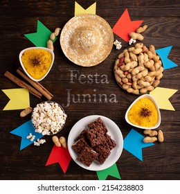 Festa Junina Summer Festival Carnival concept. Brazilian straw hat, popcorn, peanuts and colorful flags on wooden background, top view. Design for Greeting Card, Invitation or Holiday Poster