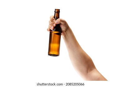 Festival drink degustation. Cropped image of male hand holding bottle of lager beer isolated over white background. Concept of alcohol, drink, party, degustation, holiday. Copy space for ad