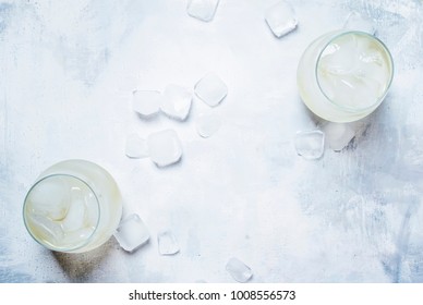 Festive Alcoholic Cocktail Prosecco On The Rocks With Dry Sparkling Wine And Ice Cubes, Gray Stone Background, Top View