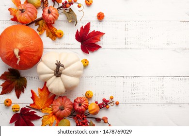Festive autumn decor from pumpkins, berries and leaves on a white  wooden background. Concept of Thanksgiving day or Halloween. Flat lay autumn composition with copy space. - Shutterstock ID 1478769029