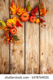Festive autumn decor from pumpkins, berries and leaves on a rustic wooden background. Concept of Thanksgiving day or Halloween. Flat lay autumn composition with copy space. - Shutterstock ID 1478769035