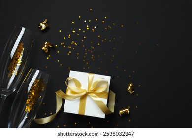 Festive background with champagne glasses, gift box and confetti, copy space composition - Powered by Shutterstock