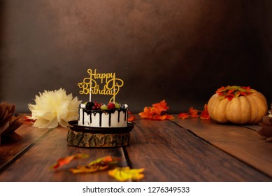 Festive background decoration for birthday celebration with gourmet cake and pumpkins in studio, cake smash first year concept 