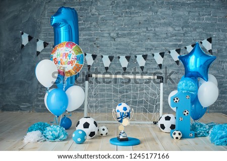 Festive background decoration for birthday, letters saying one and blue balloons in studio, Boy Birthday .Cake Smash first year concept. birthday greetings. Football theme