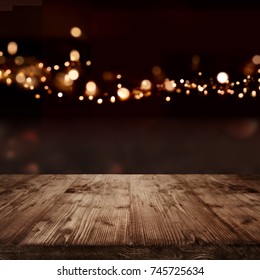 Festive Background With Golden Bokeh Effects And Empty Wooden Table For A Christmas Decoration