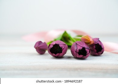 Festive Background With Tulips Lying On A Light Wooden Table. Side View, With Space To Copy. Concept Of Festive Backgrounds, March 8, Spring.