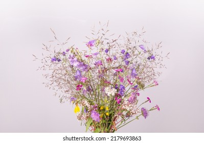 Festive bouquet of yellow and purple, blue wildflowers, herbs on gray background. Birthday, Mother's, Valentines, Women's, Wedding Day concept. - Shutterstock ID 2179693863