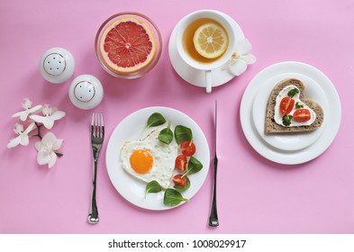 Festive Breakfast Set With Fried Egg, Rye Sandwich With Cream Cheese And Tomatoes, Grapefruit And Green Tea. Table Setting For Healthy Breakfast. Overhead View