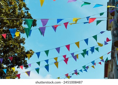 Festive bunting and lanterns decorate a narrow street for summer festival in June San Juan