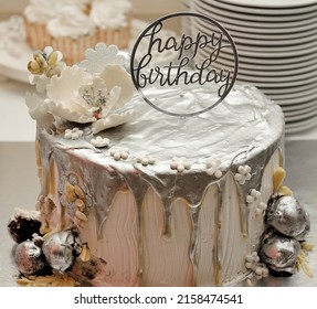 A Festive Cake With A Happy Birthday Topper For A Birthday Celebration On A Table