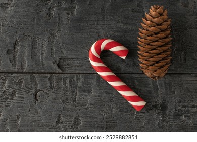 Festive Candy Cane and Pine Cone on Rustic Wooden Background - Powered by Shutterstock