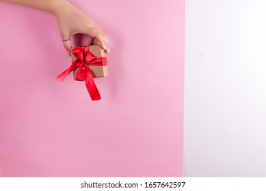 Festive card with woman's hands holding gift paper handmade box against duotone colorful wall. - Shutterstock ID 1657642597