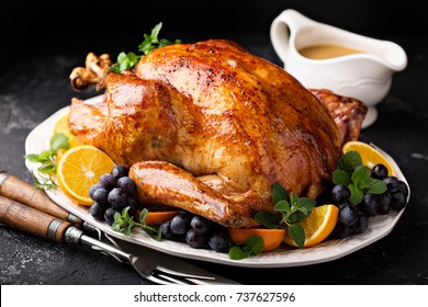Festive celebration roasted turkey with gravy for Thanksgiving or Christmas - Shutterstock ID 737627596
