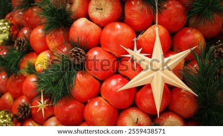 Festive Christmas Arrangement with Red Apples, Pinecones, and Star Ornament for Seasonal Celebrations and Holiday Promotions