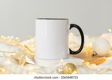 Festive Christmas background White ceramic tea mug with black handle and copy space for your imprint. Front view 11oz cup background for Christmas promotional content or branding