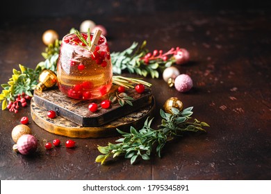 Festive Christmas Cranberry and rosemary cocktail with ice on the dark background. Alcoholic or non-alcoholic cocktail. - Shutterstock ID 1795345891