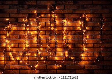 Festive Christmas garland on brick wall - Powered by Shutterstock