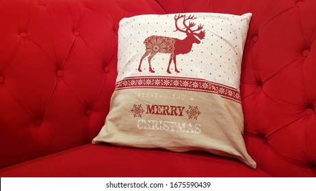 Festive Christmas Pillow With Reindeer On Red Sofa