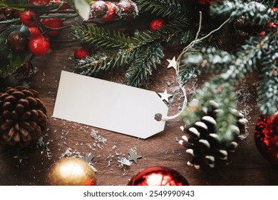 Festive Christmas scene with pinecones, red and gold ornaments, and a blank tag. Christmas decorations, pinecones, with blank paper tag. Christmas decorations elements with copy space on paper tag. - Powered by Shutterstock