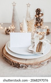 Festive Christmas Table Setting With Golden Cutlery And Porcelain Plate And Christmas Decoration. Mockup For Place Card, Dinner Invitation, Restaurant Menu Template. Copy Space