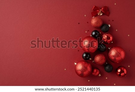 Festive Christmas tree created with red and black ornaments on a red background, symbolizing the joy and creativity of holiday decorations