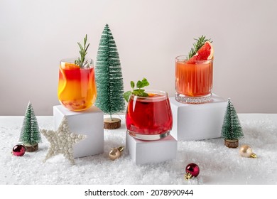 Festive citrus cocktails on podiums. Assortment of fresh Christmas drinks. Pink and red sangria cocktails, pomegranate  jingle and citrus tequila smashy. - Powered by Shutterstock