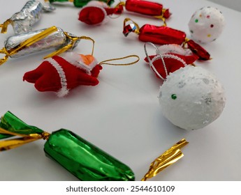 a festive collection of Christmas ornaments, including candy canes, Santa Claus figurines, and a snow globe, perfect for holiday decorations or crafts. - Powered by Shutterstock