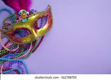 Festive, Colorful Group Of Mardi Gras Or Carnivale Mask On Purple Background.