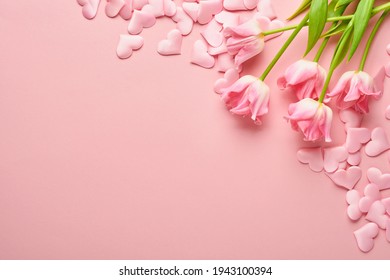 Festive composition with beautiful delicate tulips flowers in pink round box on light background. Flat lay, copy space. Spring Greeting card.