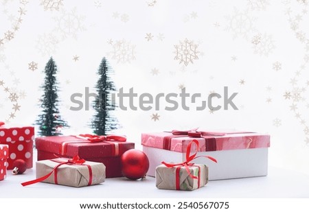 Festive composition with Christmas gift boxes and decorations on white background with decorative snow flakes close up.
