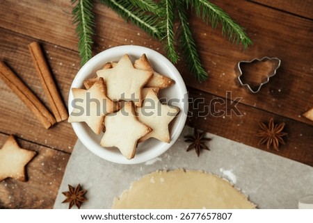 Festive cookie dough and baking setup on wooden table for christmas culinary and rustic food concept