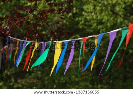 red white and green white pennants on the garden fence