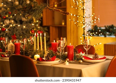 Festive dining table with Christmas setting in room at night
